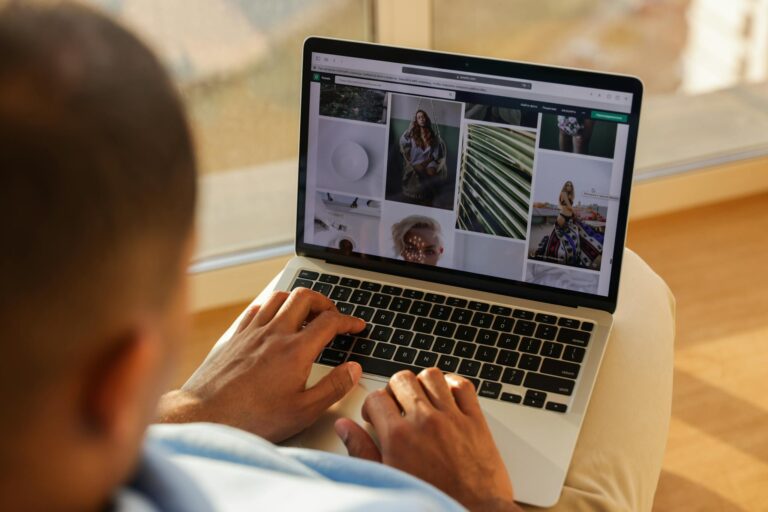 Close-up of a person using a laptop indoors while browsing a photography portfolio.